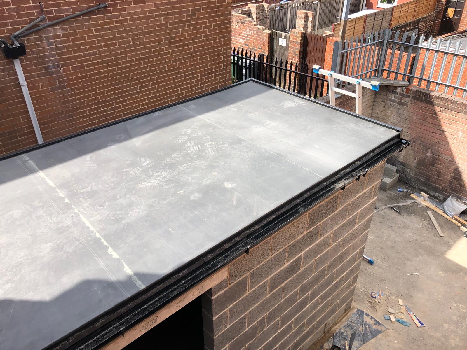 New flat roof on a brick extension with black drip trim