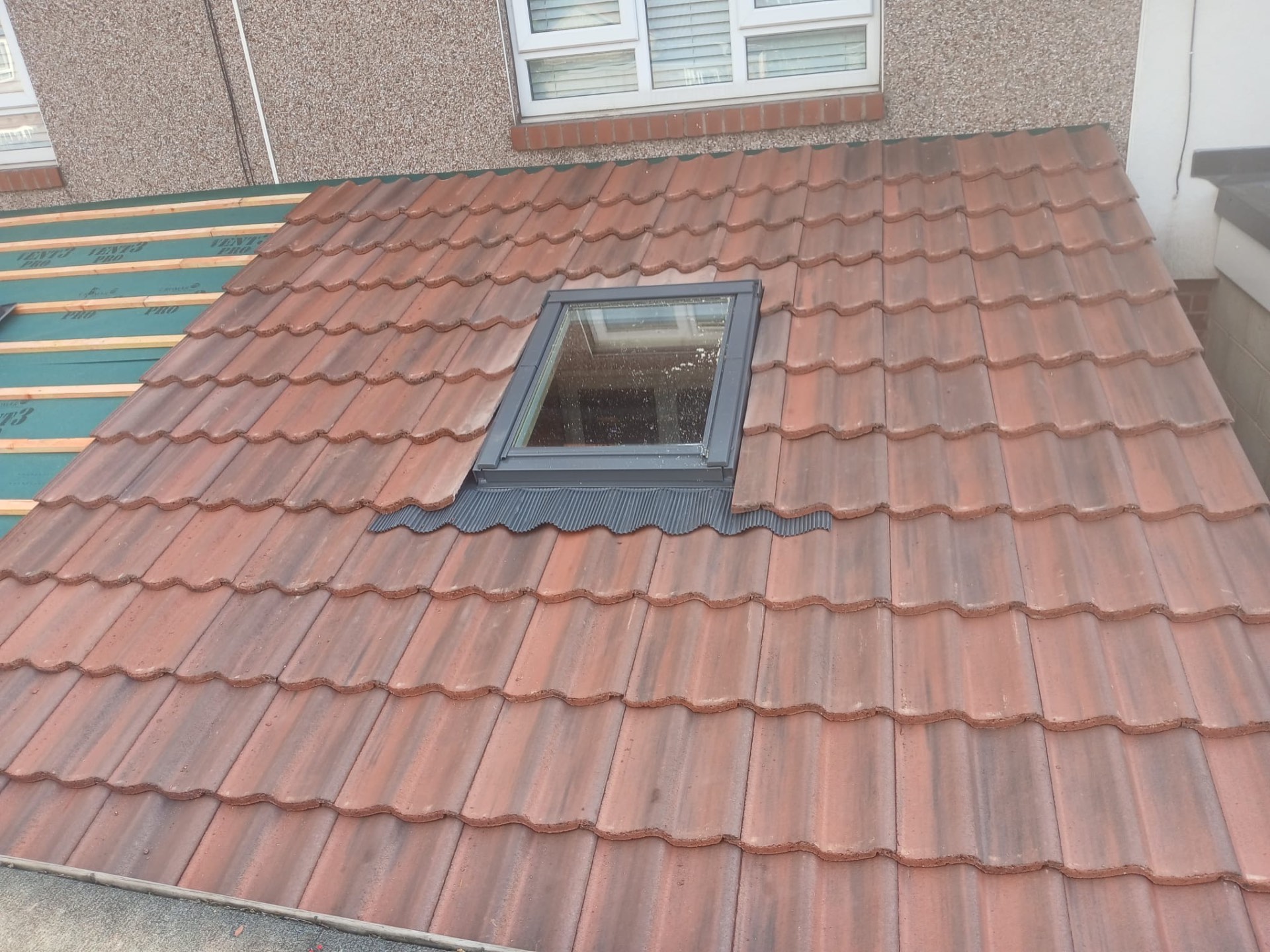 New clay roof tiles with skylight fitted